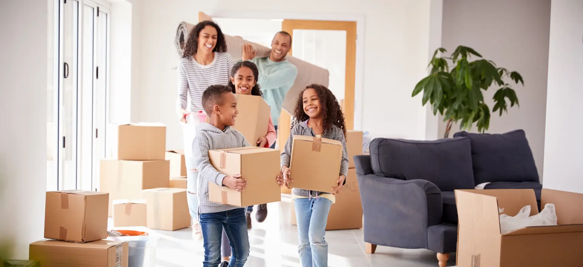 Happy family moving in to their new home thanks to America's Home Loans